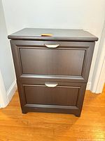Front view of closed file cabinet showing finish and hardware