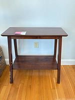 Front view of dark brown side table with shelf
