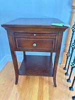 Front view showing drawer, pull-out tray and shelf