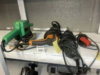 Green Hitachi orbital sander, orange grinder, black reciprocating saw, cords on shelf