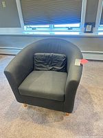 Front view showing overall chair, upholstery, cushion and legs