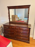 Front view of dresser with mirror attached, drawers closed