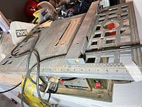 Overall view of Makita 2708 table saw with dust bag and rip fence