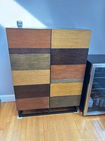 front view showing multi-tone wood panels and metal base