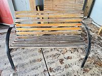 Full front view of bench showing wood slats and metal frame