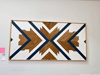 Front view of framed geometric wood and mixed media wall art