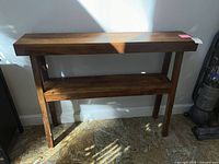 Front view of solid wood console table with lower shelf