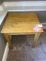 front corner view of square light oak side table