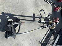 Both string trimmers side by side on pavement