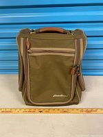 Front view showing logo, compartments, leather handle