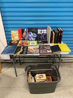 Wide shot of table with all visible books and tote below