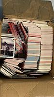 Cardboard box filled with large stack of trading cards