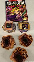 Stacks of Yu-Gi-Oh! cards and scrapbook book