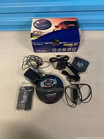 All items laid out including player, adapters, remote, mount, hardware, box