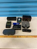 Group shot of all electronics with ruler for scale