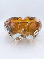 Front angle of amber cased glass bowl showing freeform contours