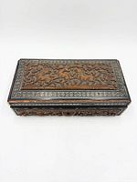 Top view showing carved animal and foliage scene and Sadeli borders