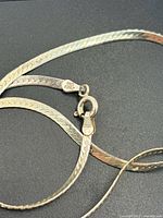 Close-up of clasp stamped 925 Italy showing herringbone links