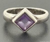 Front view of sterling silver ring with square purple stone