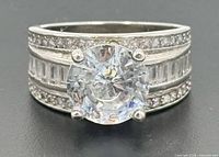 Front view of sterling silver ring showing center stone and side stone arrangement