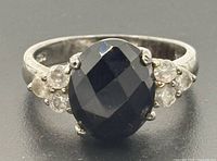 Top view showing oval black stone and clear accents