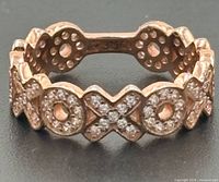Front view of ring showing XOXO pattern and stones
