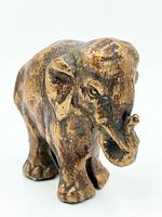 Front angled view of distressed brass elephant figurine