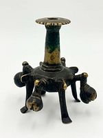 Full view front of bronze candle holder showing column, legs and bells