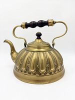 Right side view of brass kettle showing ribbed body, handle, spout