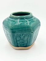 Front view showing hexagonal shape, glaze and relief panels