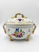 Front view of tureen showing floral painting, gold gilt, handles and feet