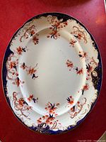 Front view showing full Imari floral design and scalloped cobalt border