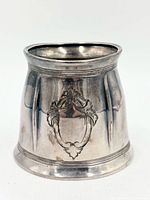 Front view of silver mug showing baluster shape and engraved cartouche