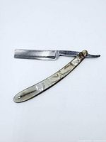 Full view of razor open showing blade and handle