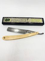 Straight razor with closed case showing Bismarck Solingen label