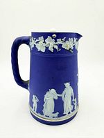 Front view showing blue Jasperware body, white relief, rope handle