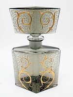 Front view of decanter showing body, stopper, etched and gilt design