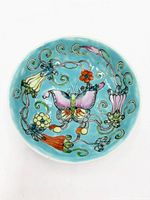 Top view showing turquoise ground, butterfly and floral motifs