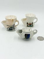 All three miniature porcelain shaving scuttles with coin for scale