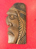 front view showing carved Indigenous profile detail