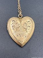 Front view of etched gold-filled heart locket on chain