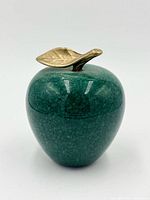 front view of green stone apple paperweight showing brass leaf and stem