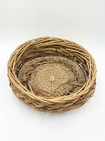 Interior view of round wicker basket showing woven base and rim