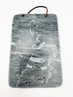 Front view showing full carved scene and hanging cord