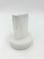 Full view of raw selenite crystal on staging base