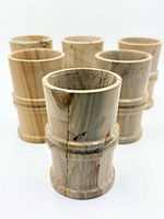 front view of six petrified wood cups