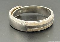 Side view of ring showing overlapping band and hallmark 999