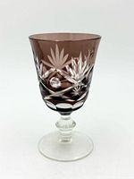 Front view showing floral and geometric cuts on purple overlay and clear stem