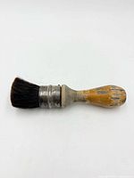 Shaving brush side view showing handle, metal collar, bristles