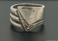 Front view of ring showing triple bands and textured chevron